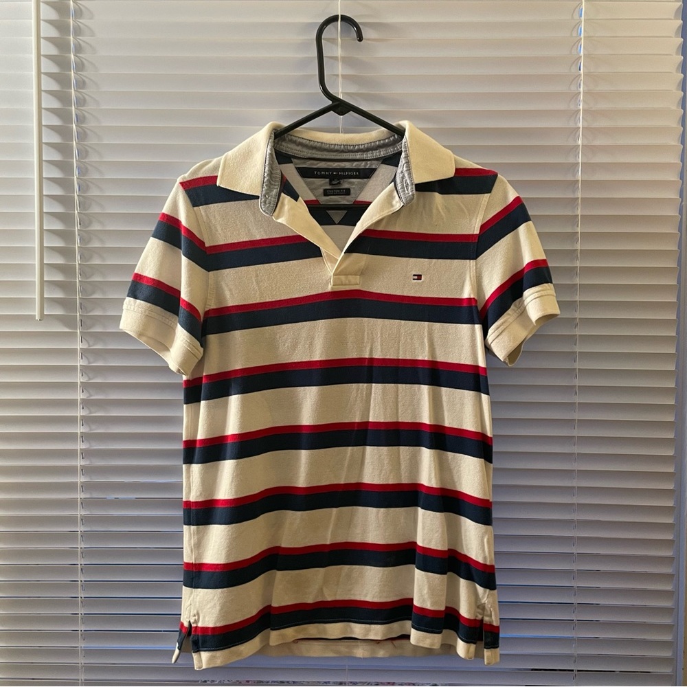 Tommy Hilfiger 
Red, white, and blue striped polo shirt. 
Unisex size XS